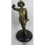 A late 19th/early 20th century gilded metal sculpture cast as a Cavalier, on ebonised base,
