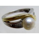 A 14ct white and yellow gold ring set with centre pearl and baguette cut diamond shoulders,