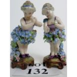 A pair of late 19th/early 20th century German flower-encrusted porcelain figures, 17 cm high,