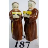 A pair of Royal Worcester porcelain candle snuffers, modelled as Friars, 20th century,