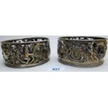 A pair of early Cork silver coasters decorated with cherubs and vines, one marked 'CT',