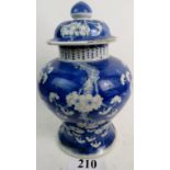 A 19th century Chinese blue and white porcelain vase and cover, painted with Prunus blossoms,