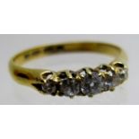 An 18ct gold 5 stone graduated diamond ring, centre diamond approx 20pts,