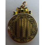 A 15ct gold locket with engraved decoration, total weight 5.