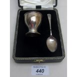 A cased silver egg cup and spoon,