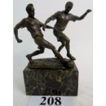 A reproduction bronzed metal group of vintage footballers, on marble plinth base, 22cms high.