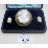 A large cameo brooch/pendant, with matching earrings,