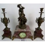 A decorative 19th century French bronzed metal mounted rough marble three piece clock garniture,