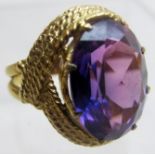 A 9ct gold ring inset with oval purple stone, possibly topaz, size K.