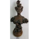 An Art Nouveau style bronzed plaster bust, modelled as a young woman in a low cut dress,