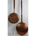 Two 19th century copper warming pans with engraved decoration, pierced lids, and fruitwood handles.