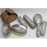 A pair of silver backed clothes brushes, Birmingham 1938, in leather case,