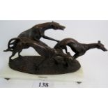 An Art Deco style bronzed metal sculpture depicting three racing greyhounds, titled "JULIANI",