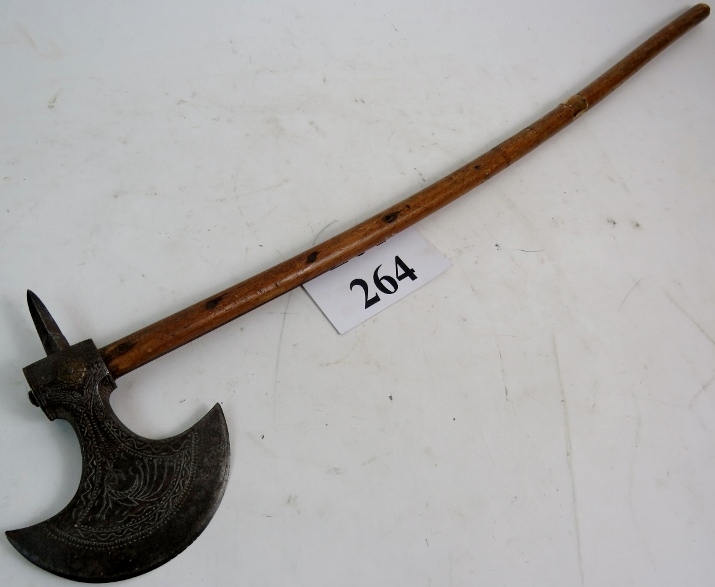 An old Tribal axe, probably c1900, having an engraved steel head and hardwood shaft, 78cm long.