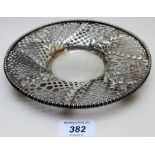 A pierced dish with flower decoration an