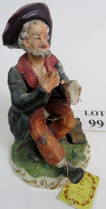 A Capodimonte of a man sewing a handkerc