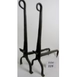 A pair of antique wrought iron fire dogs