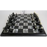 A vintage Chinese chess set with mother of pearl inlay on the box for the white squares,