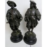 A pair of bronzed statuette's modelled as 16th/17th century noblemen, on ebonised wooden bases,