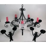 A wrought iron five branch ceiling light, together with three matching twin-branch wall lights,