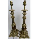 A pair of ornate rococo-revival gilt-metal table lamps, 50cm high,
