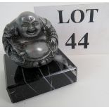 A small modern Tibetan Buddha, bronzed, on a marble base, 6cm wide,