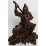 A highly decorative and well carved Chinese wooden model of a warrior,