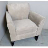 A contemporary grey velour armchair with