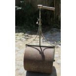 An ornate iron garden roller est: £40-£6