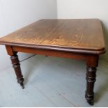 A Victorian oak wind out dining table, w