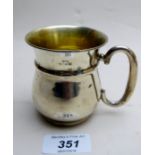 A silver christening mug with gilded int