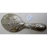 A silver hand mirror, heavily embossed w