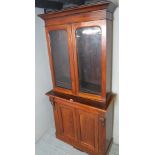 A late Victorian walnut bookcase with ar