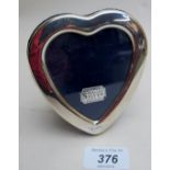 A silver heart shaped photo frame, fully