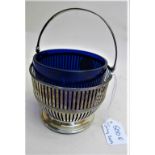 A sterling silver sugar basket with blue