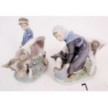 A matched pair of Royal Copenhagen porcelain figures, `Boy with Calf', 772, and `Girl with Calf',