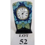 Moorcroft mantle clock with ceramic case in a floral pattern with a predominantly blue palette,