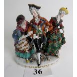 A 19th century Continental porcelain figure group modelled as an 18th century Dandy and two female