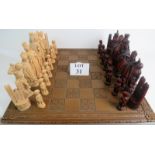 A modern Medieval-style resin chess set (king 20cm), with carved wooden chess board,