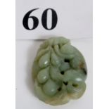 A celadon Jade carving of a monkey with a bunch of grapes, 55mm tal,