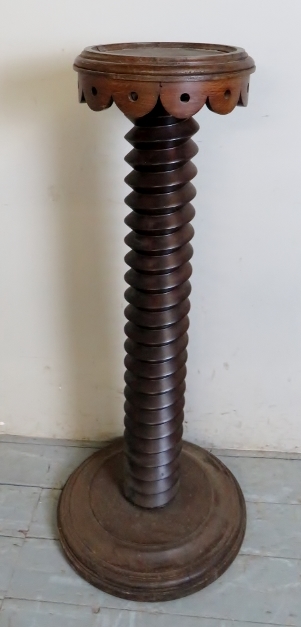 A converted carved torchere stand,