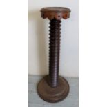 A converted carved torchere stand,