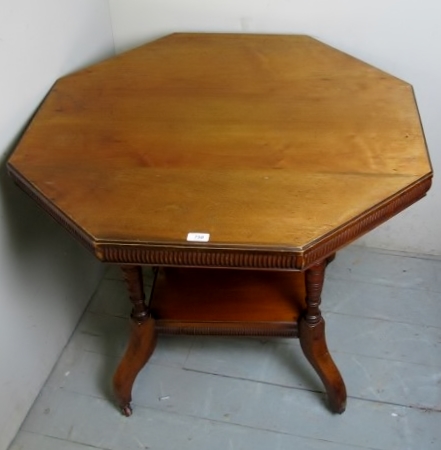 A late Victorian octagonal centre table with carved soldiered frieze over turned legs and shelf