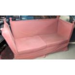 An Edwardian knoll sofa upholstered in a pale pink material, 2/3 seater,