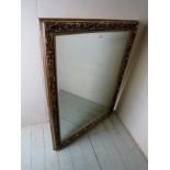 A late 20th century silver coloured carved framed wall mirror, 55.