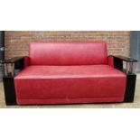 An Art Deco design stylish leather sofa upholstered in a rose leather with sweeping black arms over