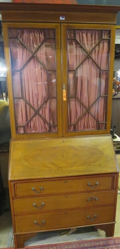 An Edwardian mahogany inlaid bureau bookcase with astral glazed top,