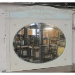 A 19th century painted over mantle mirror with an oval bevelled edge glass,