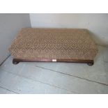 A late 19th/20th century oak framed footstool with ball feet, 34" x 18",