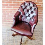 A 20th century burgundy button back leather swivel desk chair,